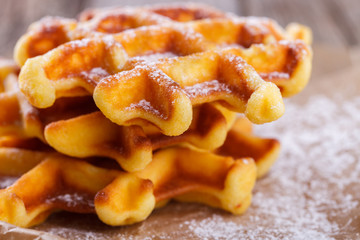 Belgian waffles sprinkled with powdered sugar,closeup.selective focus
