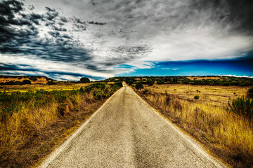 country road under a dramatic sky in hdr