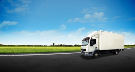 Obraz na płótnie Canvas White Delivery Truck on the Road