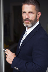 portrait of businessman smoking a cigarette