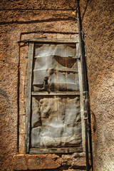 broken window in an old wall in hdr