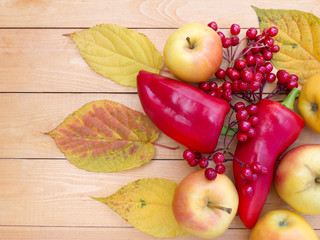 Apples, bell peppers, red viburnum berries and autumn leaves