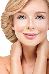 Beautiful face of young adult woman with clean fresh skin. Looki