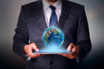 Earth with tablet computer business technology