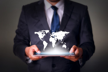 World map with tablet computer business technology