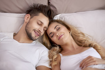 Fototapeta na wymiar Couple napping in the bedroom