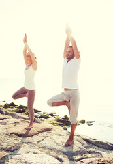 couple making yoga exercises outdoors