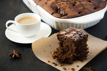 Chocolate cake with espresso on dark background