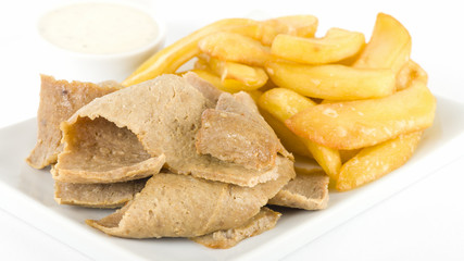 Donner Meat & Chips - Spicy lamb kebab slices served with fries and yogurt sauce on a white background.

