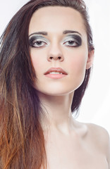 Fototapeta premium Makeup artist applies eye shadow. Beautiful woman face. Perfect