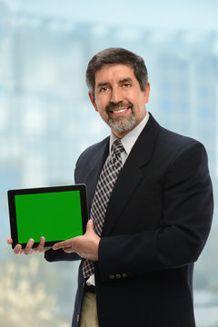 Hispanic Businessman Displaying Electronic Tablet