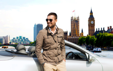 happy man near cabriolet car over london city