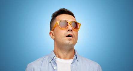 face of scared man in shirt and sunglasses
