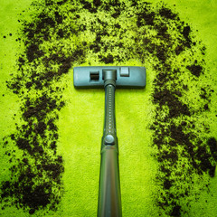 High Angle View Of Vacuum Cleaner Cleaning Dirt On Carpet