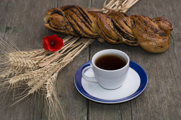 roll, wheat ears, flower of poppy and coffee