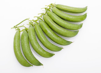 Fresh green peas pods on a white background.