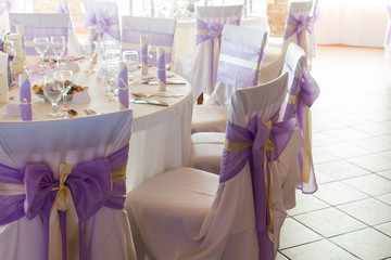 wedding or dinner table place setting, decorated chairs