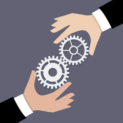 Two businessman hands with gears