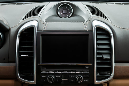 Luxury car dashboard. Multimedia screen. Interior detail.