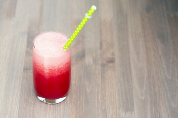 Watermelon smoothie in a glass on wooden table