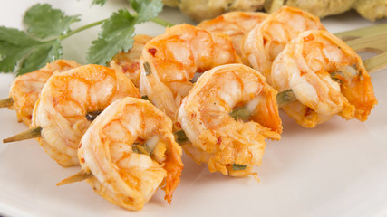 Sate Goong - Thai prawn satays served with peanut sauce. Close up.