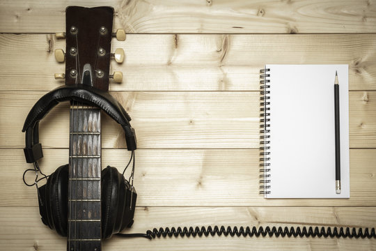 Old Guitar on the Wood Background