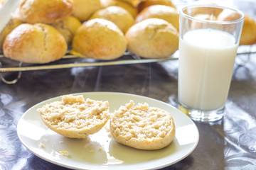 baked bread and buns and a glass of milk