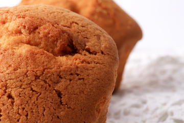 fresh homemade cupcakes close-up on a white wooden background lace soft selective focus