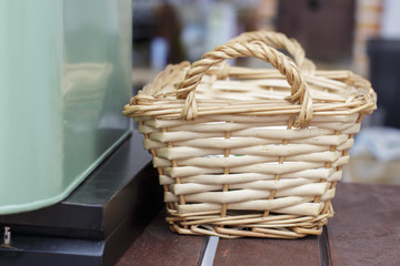 Small wicker basket beside a green metal box for crockery