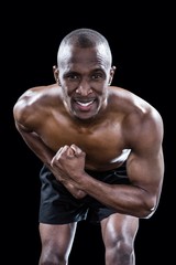 Fototapeta premium Portrait of muscular man flexing muscles