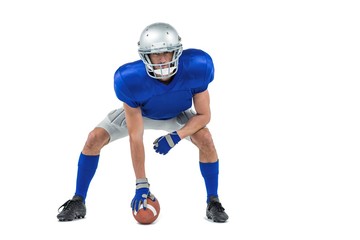 Alert American football player in attack stance