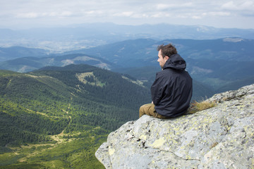 Man sitting on a rock. Carpathian mountains.