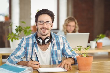 Portrait of businessman using digital tablet in bright office