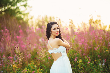 Woman with beauty long brown hair standing in field