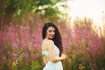 Fototapeta na wymiar Woman with beauty long brown hair standing in field