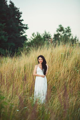 Fototapeta na wymiar beautiful young woman in a field