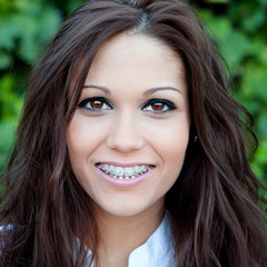 Fototapeta premium Portrait of a beautiful brunette girl with brackets