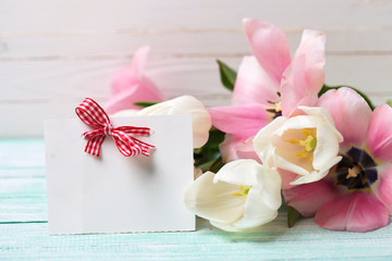 Postcard with fresh spring flowers and empty tag for your text