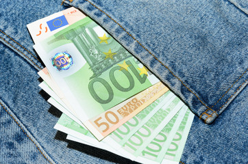 Euro banknotes in jeans back pocket
