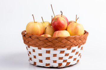 apples in a basket on white background