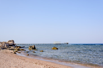 Fototapeta na wymiar Tropical bay with a wooden jetty or pier