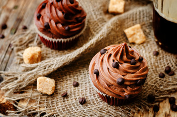 Obraz na płótnie Canvas chocolate cupcakes with chocolate frosting and chocolate chips