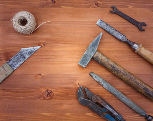 old rusty construction instruments on the wooden background