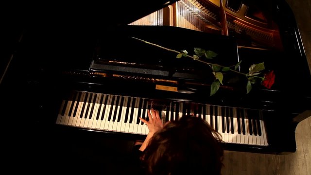 Two hands playing  on a beautiful grand piano.