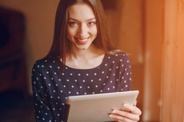 beautiful young girl enjoys phone and tablet