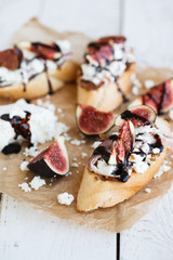 Bruschetta with figs,goat cheese and balsamic sauce.selective focus