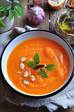 Vegetarian pumpkin soup with garlic, basil and olive oil