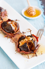 Baked figs with cheese wrapped in bacon.selective focus