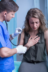 Coughing woman in doctor's office