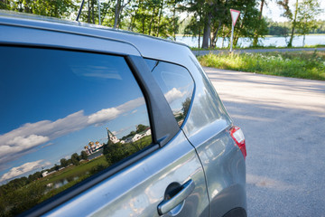 Iversky monastery is reflected in a side window of the car